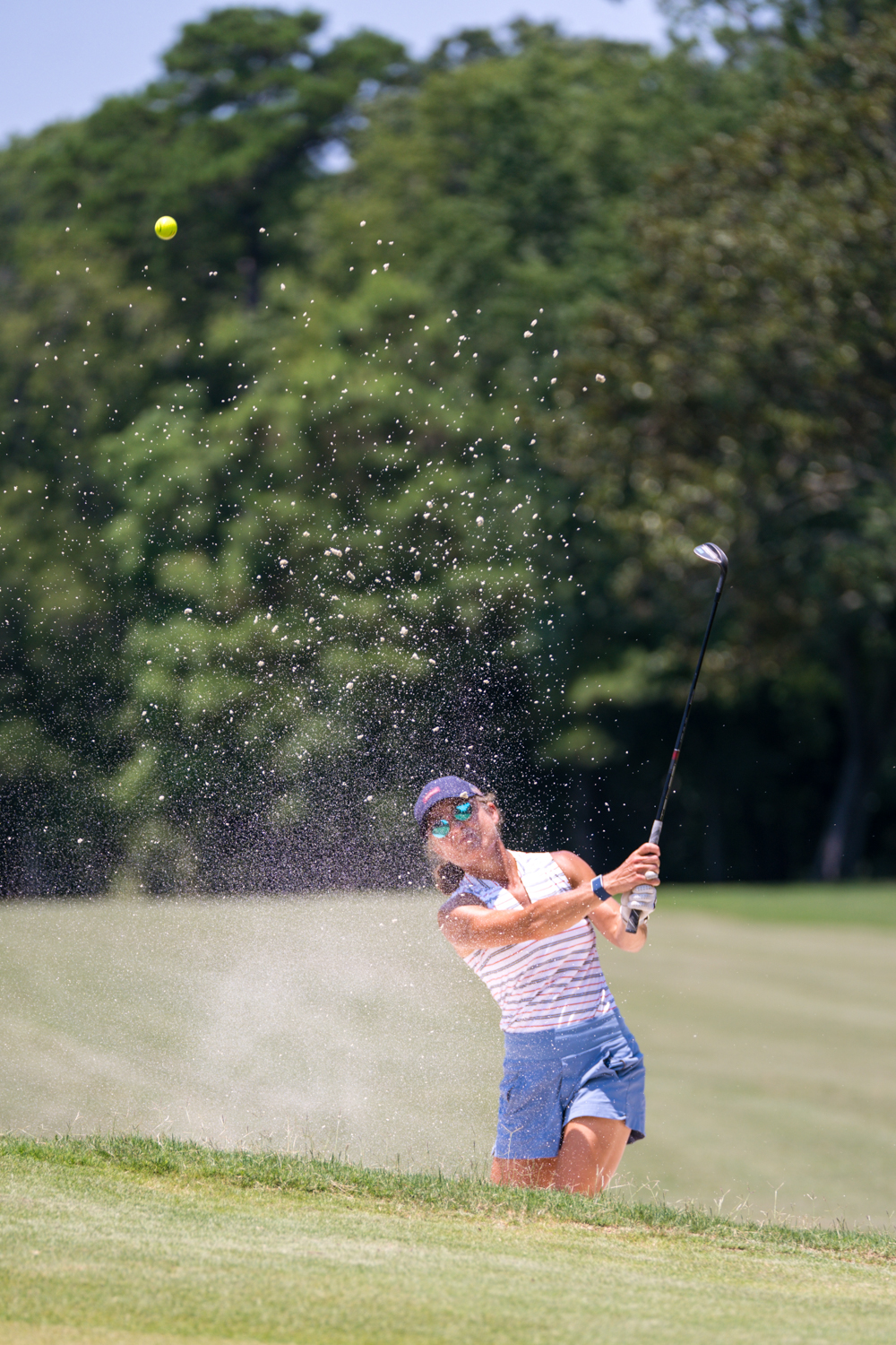 Denise blasting a bunker shot on the course